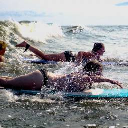 Students surfing on a trip.