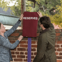two people lift sign for reserved parking