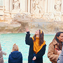 female student standing in fron of a fountain in Italy