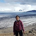 female student standing on a beach in Chile