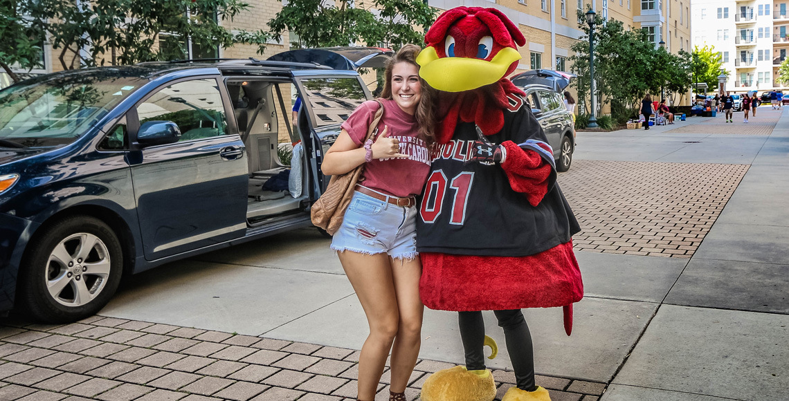 girl gives thumbs up standing next to cocky