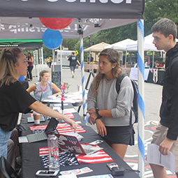 A student talks to other students about voter registration on Greene Street.