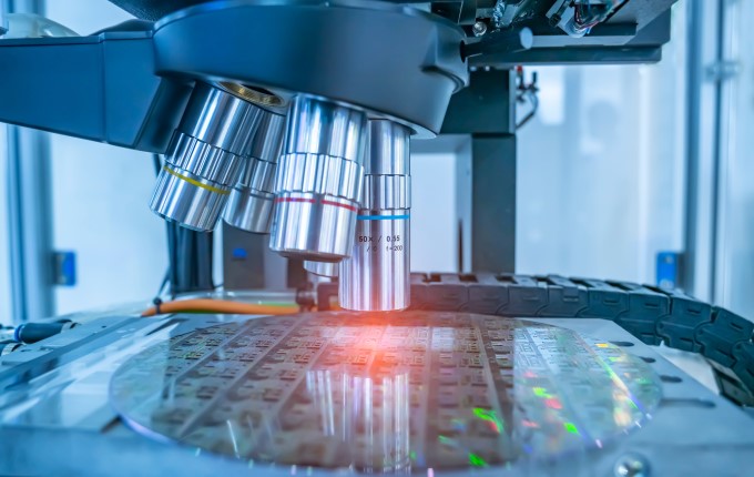 A powerful microscope examines samples under glass.