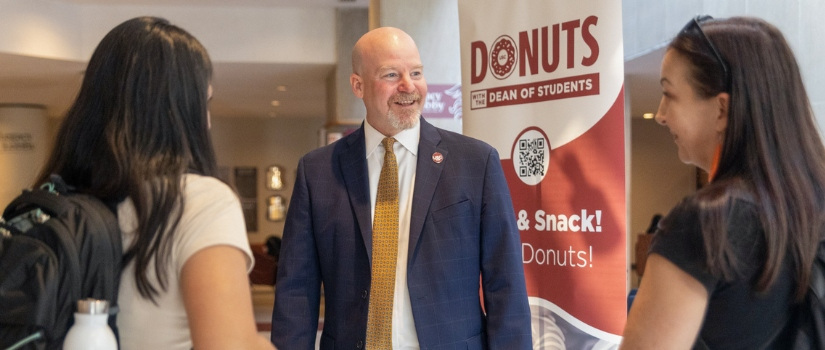 dean of students talking with two students