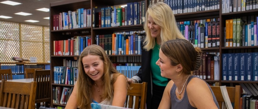 librarian helping a student on a computer in the Thomas Cooper Library