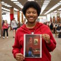 student winner holding photograph