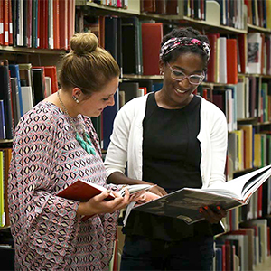 Students reading books in the library.