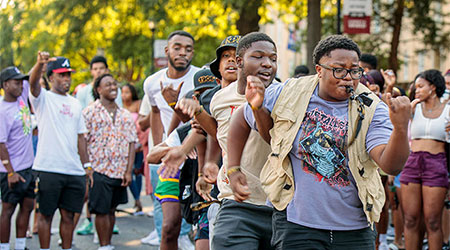 Students dancing in a line on Green Street.