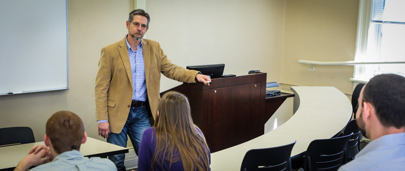 Students in a classroom taking notes