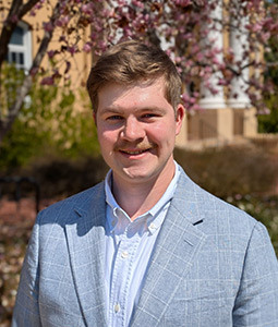 man with white polo shirt on outside