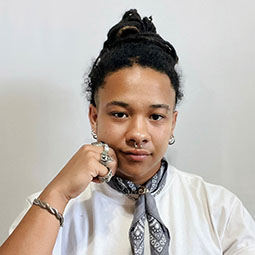 a woman in front of a white background with white tshirt on
