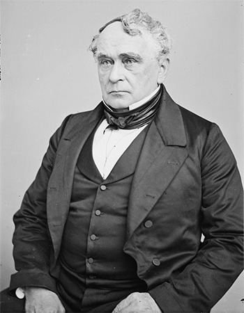 Black-and-white portrait of Francis Lieber, a 19th-century man wearing a formal suit with a cravat, seated and looking forward with a serious expression.