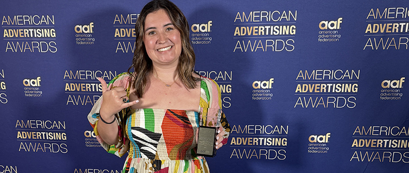 Finley Edwards holding her ADDY award