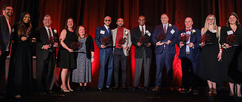 Winners of the HRSM Alumni Awards display their awards.