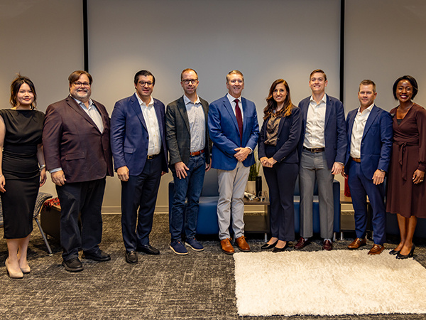 Hotel industry executives pose for a photo with members of the College of HRSM