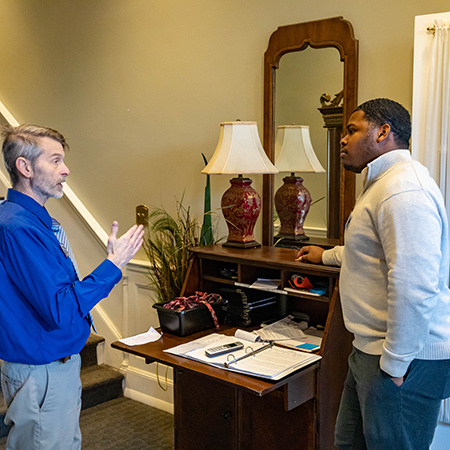 A student receives instruction from George Hendry at McCutchen House.