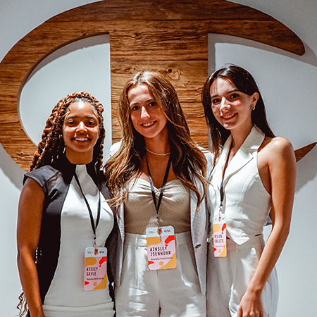 Three retailing students pose for a photo together at New York Fashion Week during September 2022.