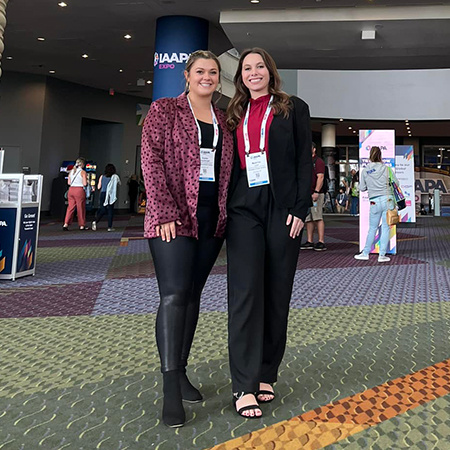 Two students attending the IAAPA Expo pose for a photo