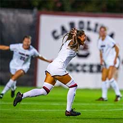 Elexa Bahr Elexa Bahr runs across the soccer field to celebrate a score with her team.