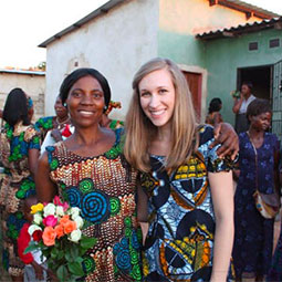 Amy Bardi with one of her students. Amy Bardi, the founder of Clothed in Hope, stands with one of her students and several other colorfully dressed women at their graduation from the Clothed In Hope program in a village in Zambia..