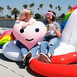 Rachel Gannon Rachel Gannon and a friend sit on their colorful fun pool floats at the edge of a pool