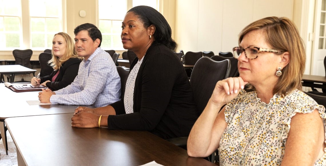 This is a photograph of a presenter at a podium speaking to an audience in the law school auditorium.