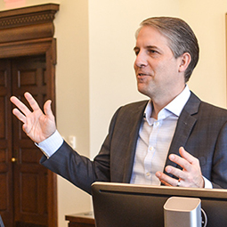 Professor Black teaching from behind a podium.
