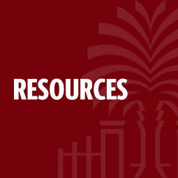 Professor Black teaching from behind a podium.