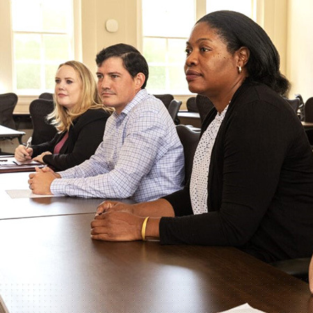 Individuals lined up at table