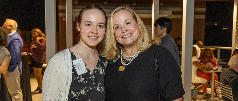 three alumni smiling