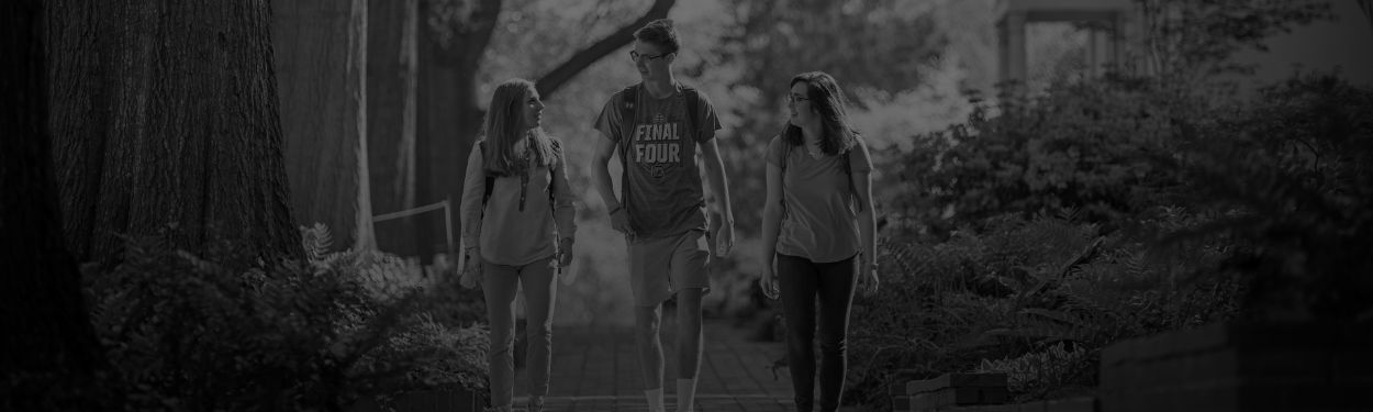 Three students walking on campus