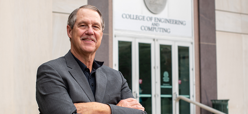 Michael Sutton stands in front of the UofSC College of Engineering and Computing.
