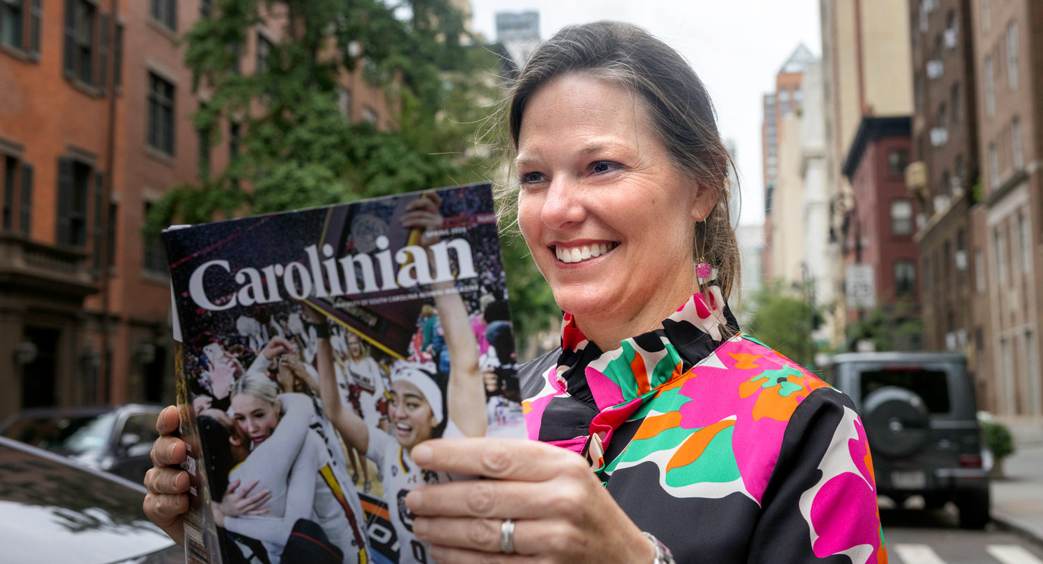 Angie Fellers, ’01 journalism, reading Carolinian magazine in Manhattan.