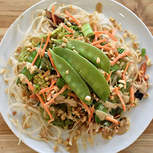 a plate of cooked vegetables on a bed of rice