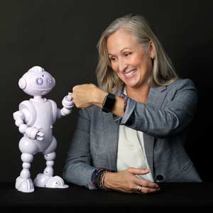 Van Robotics founder Laura Boccanfuso fist bumps ABii, her robot tutor.