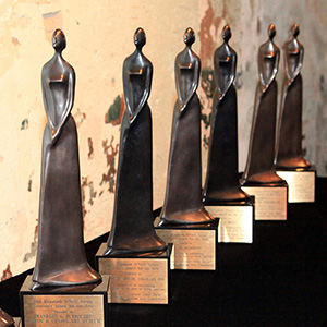 Award statues aligned on a table