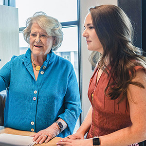 Two women working together at a desk