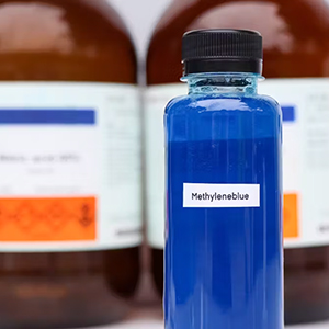 A row of pharmacy bottles with methylene blue in foreground.