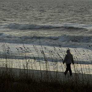 Person walks on a beach in South Carolina ahead of a storm. 