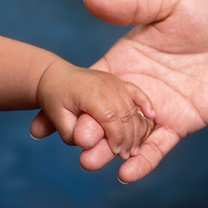 Baby hand in adult hand