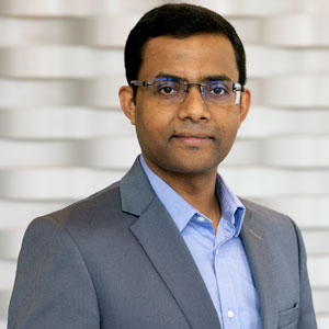 man stands in front of a textured wall