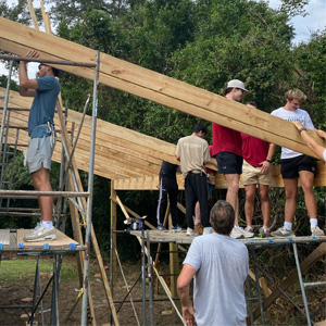 Students work to build a home.