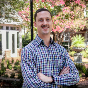 A man standing in front of a garden 